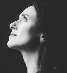 side profile of a woman looking up black and white photo