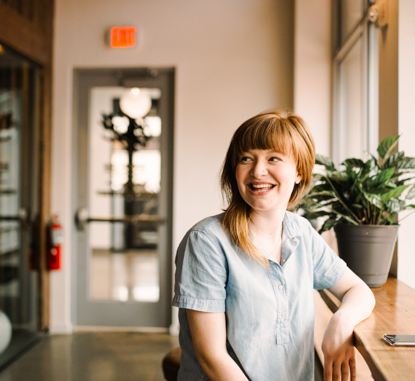 smiling young woman sitting in cafe
