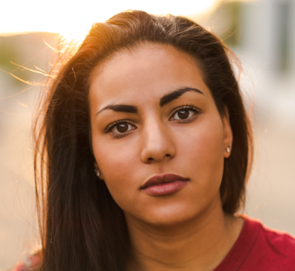 young woman headshot at sunset