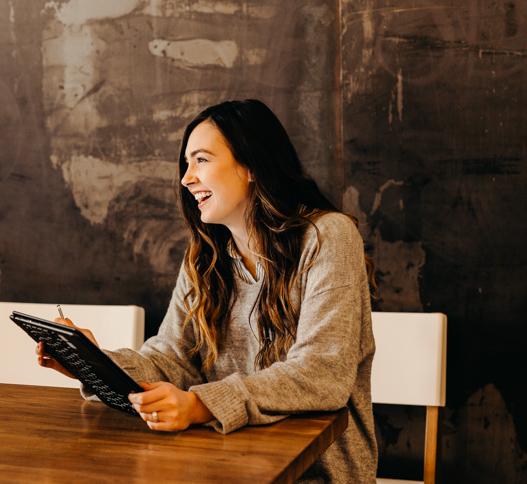woman smiling with an tablet