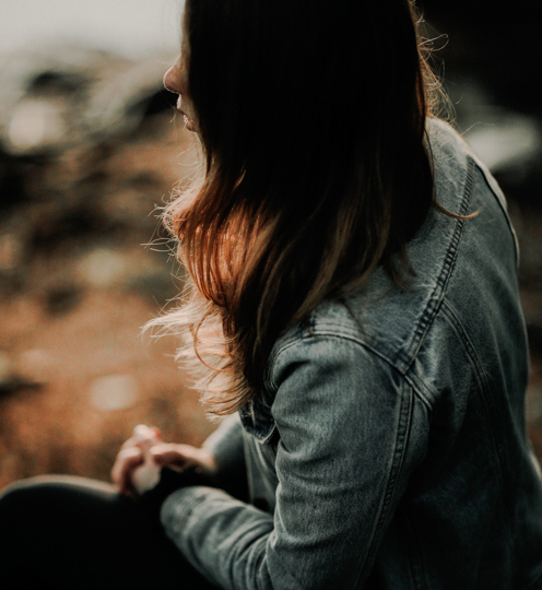 profile of woman with long hair counselling wearing denim jacket