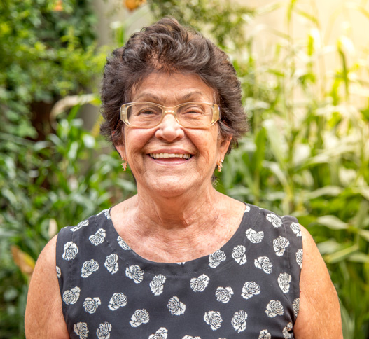 older woman smiling in the garden
