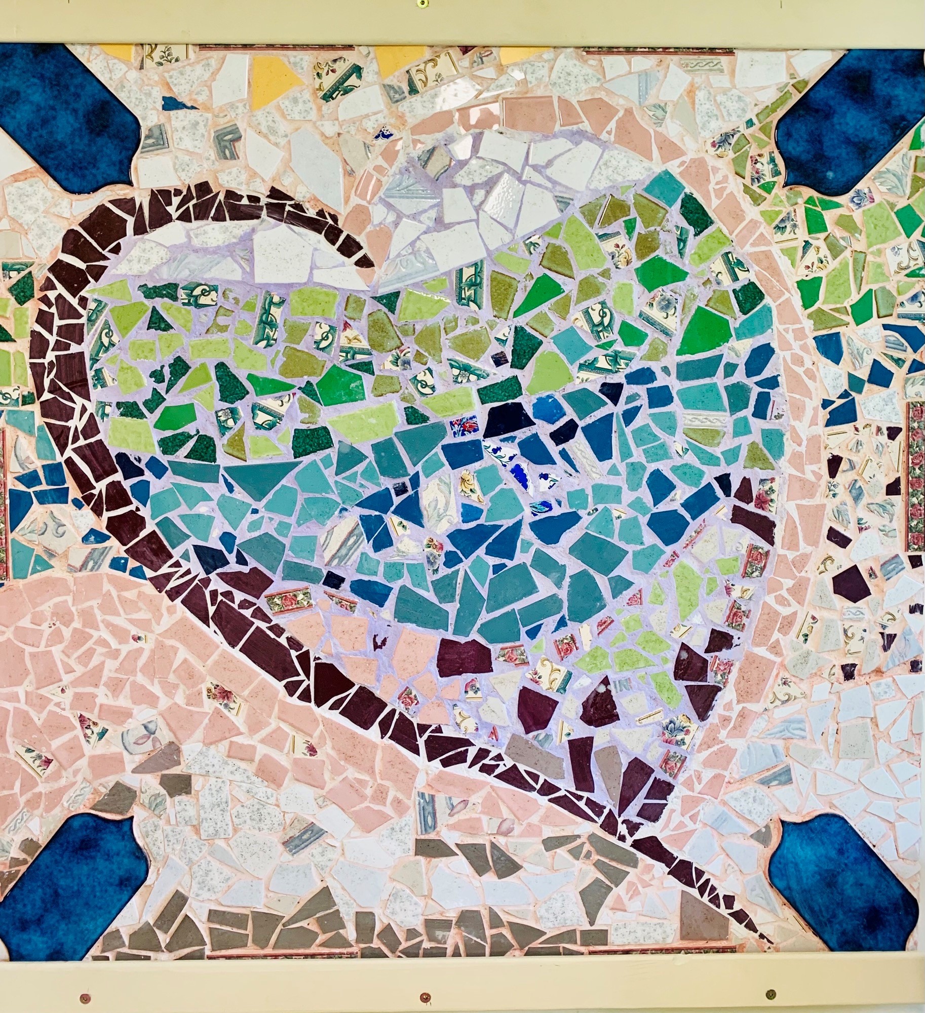 woman in blue short sitting on a stool drilling crafts