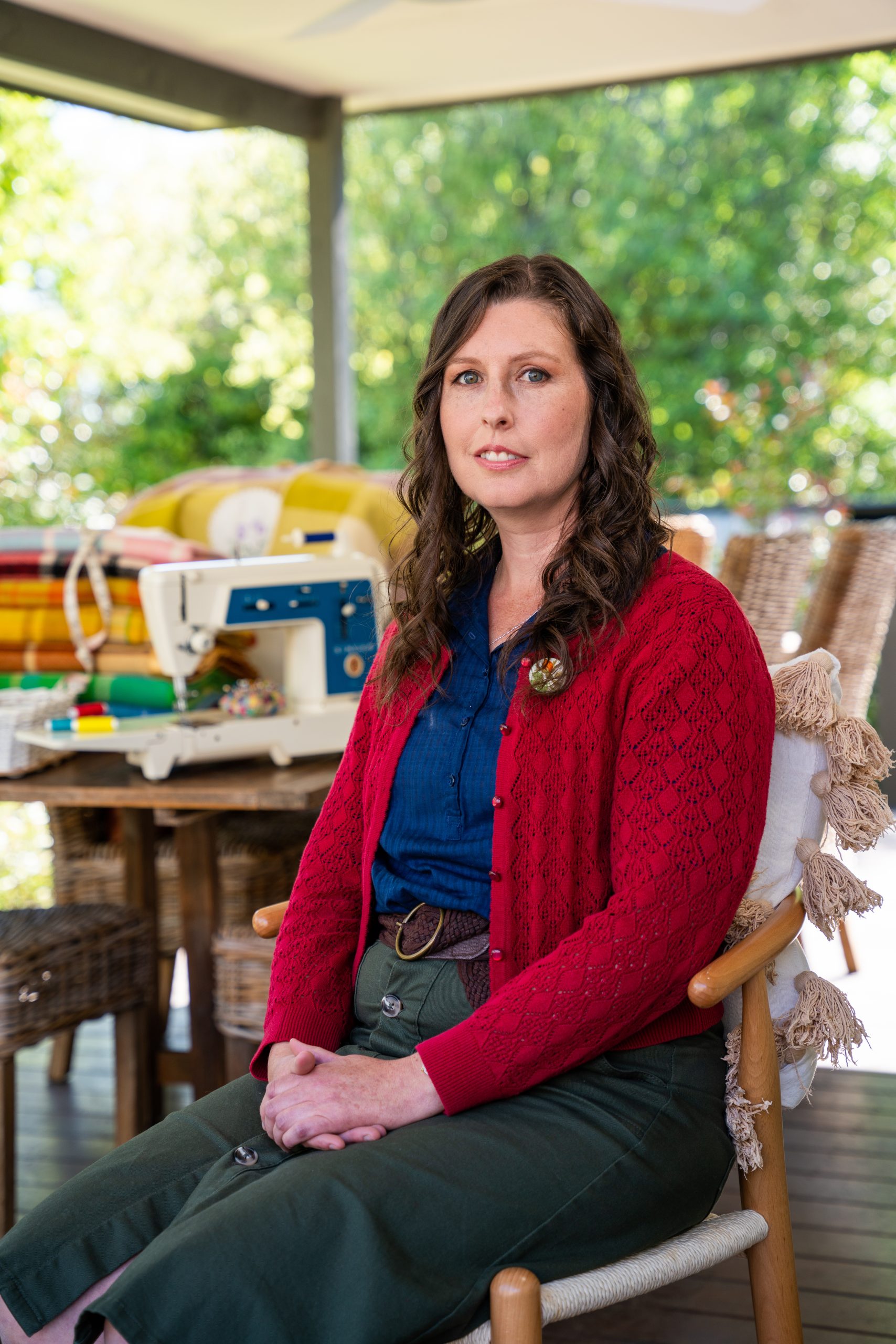 woman with brown hair in pony tail and black t shirt working on paper
